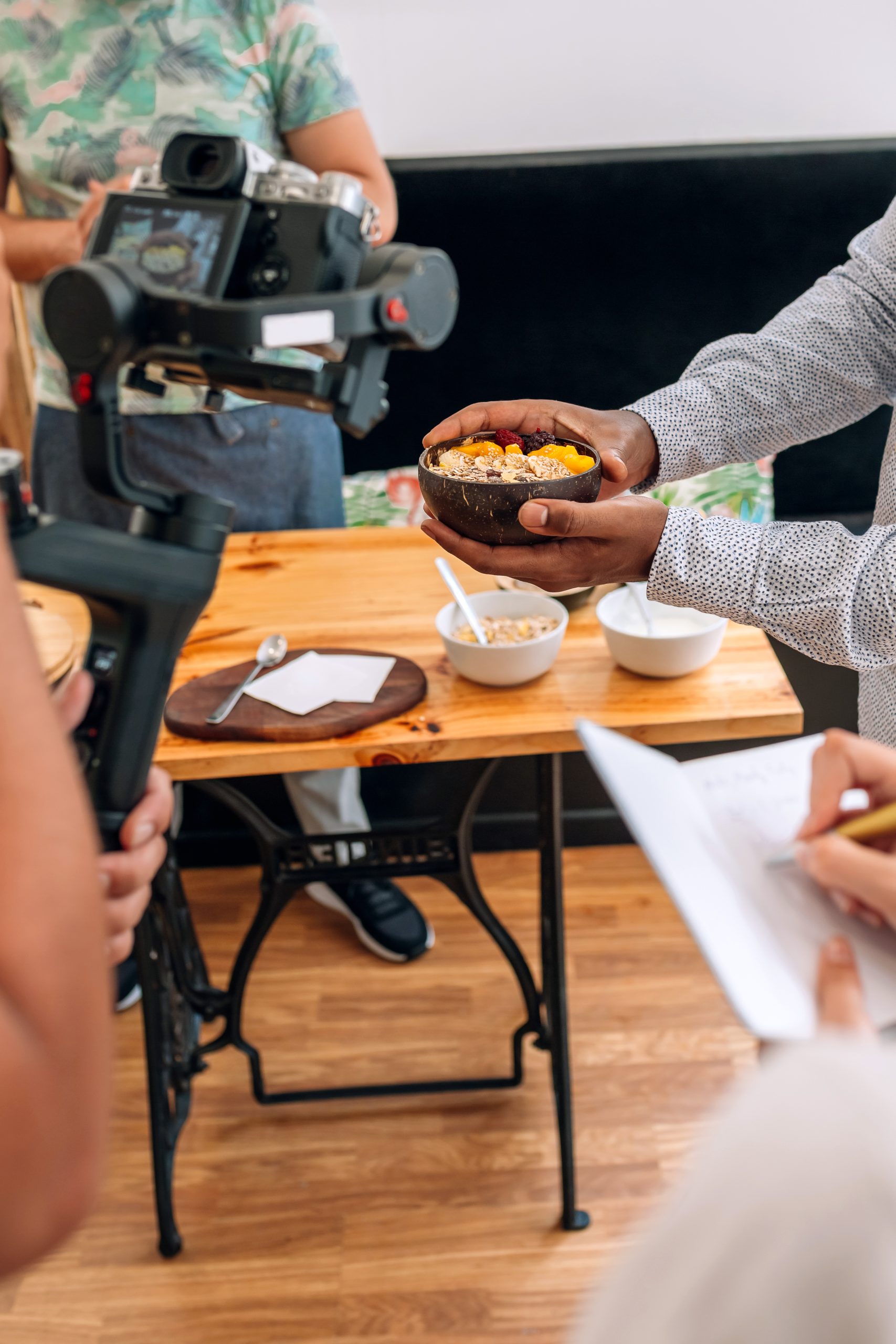 Recording a closeup of a healthy breakfast for a cooking video tutorial. Selective focus on bowl in background